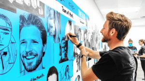 A staff member updating a shared success wall 2