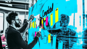 A team placing sticky notes under Completed 3