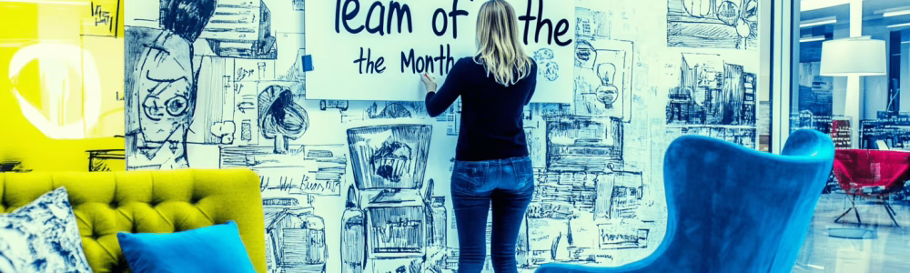 A staff member updating a shared success wall 1