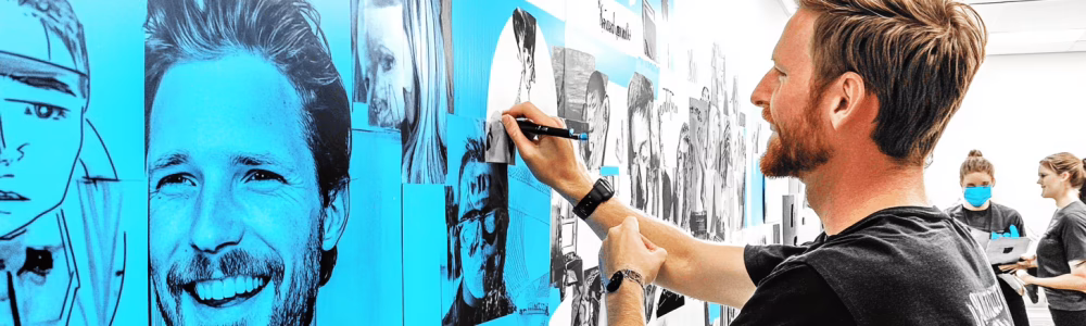 A staff member updating a shared success wall 2